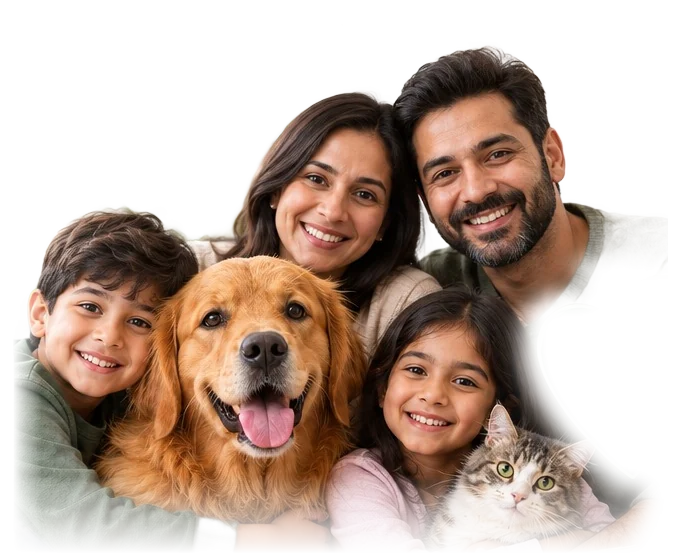 A smiling family of four hugging their golden retriever and tabby cat