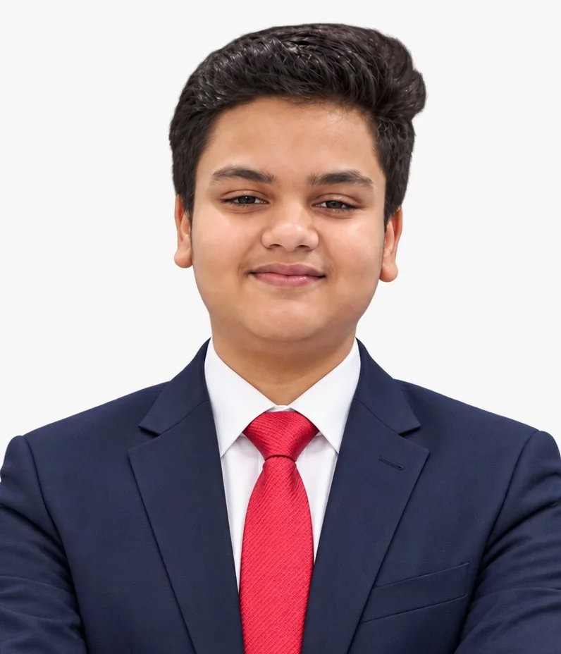 Portrait of Arnav Yuvraj K., founder of AELMIORA, in a navy suit and red tie